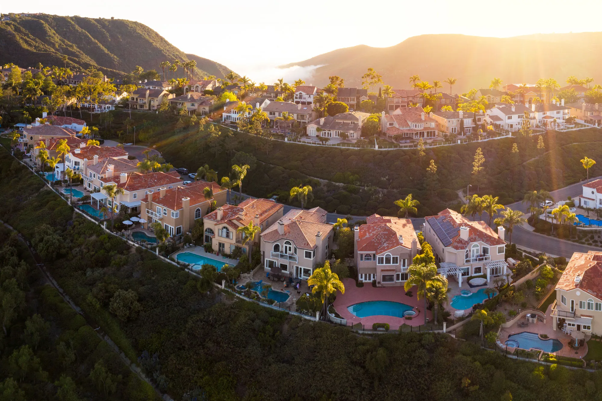 Aerial view of Luxury hillside homes with pools in a neighborhood, real estate California